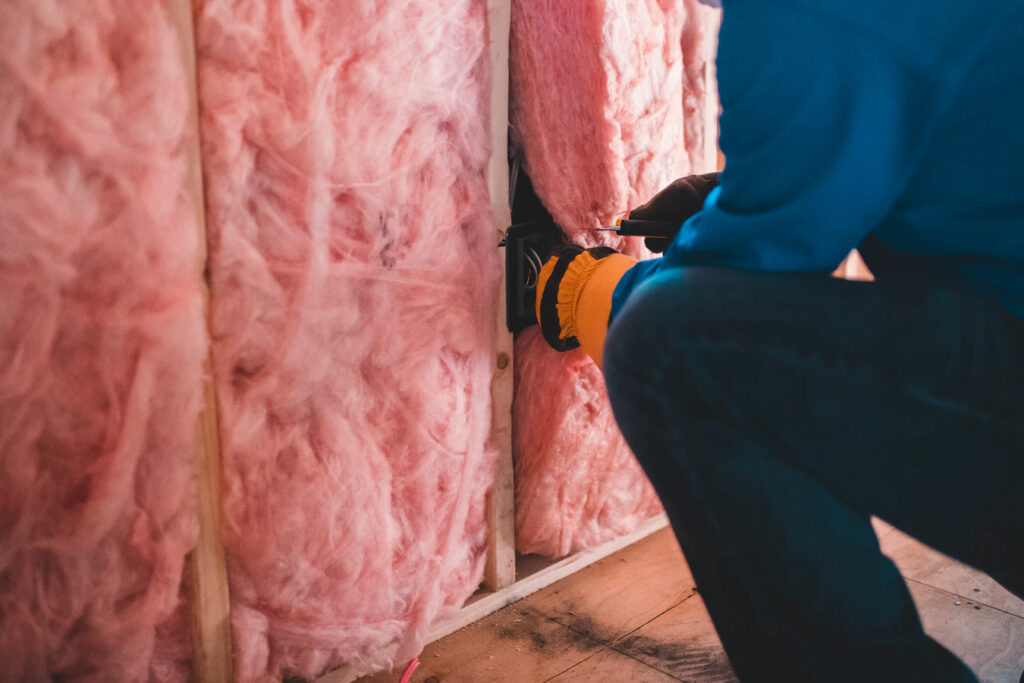 Home insulation being removed from the walls