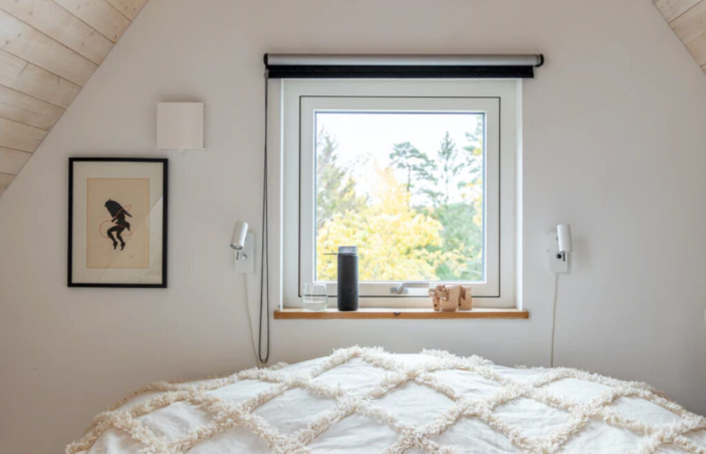 Looking over the bed in a loft room towards the view out of the window