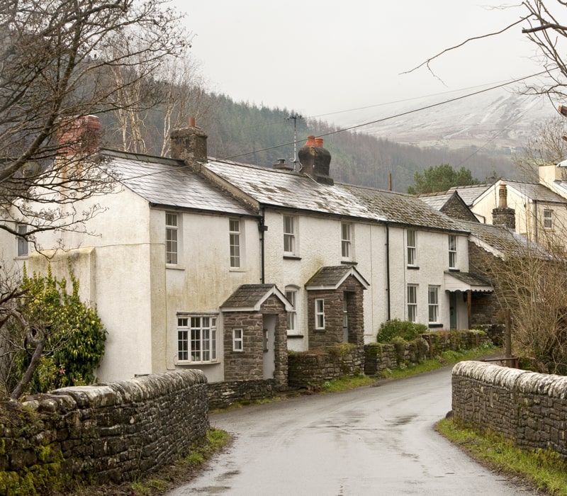 Row of traditional Welsh houses in cold snowy weather.