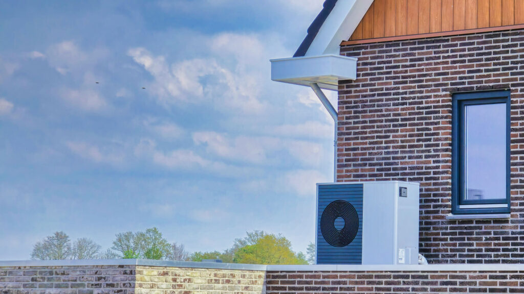 Air source heat pump on exterior of house